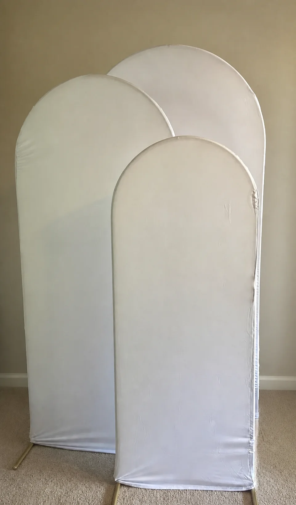 Three nested white arched fabric backdrop panels
