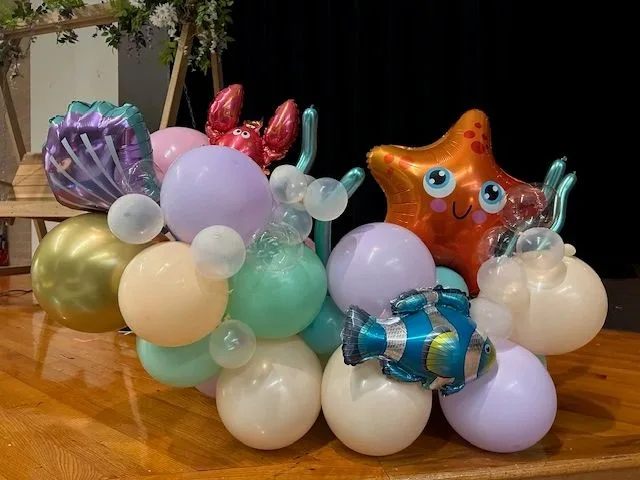 Pastel undersea balloon centerpiece with starfish, shell, and fish