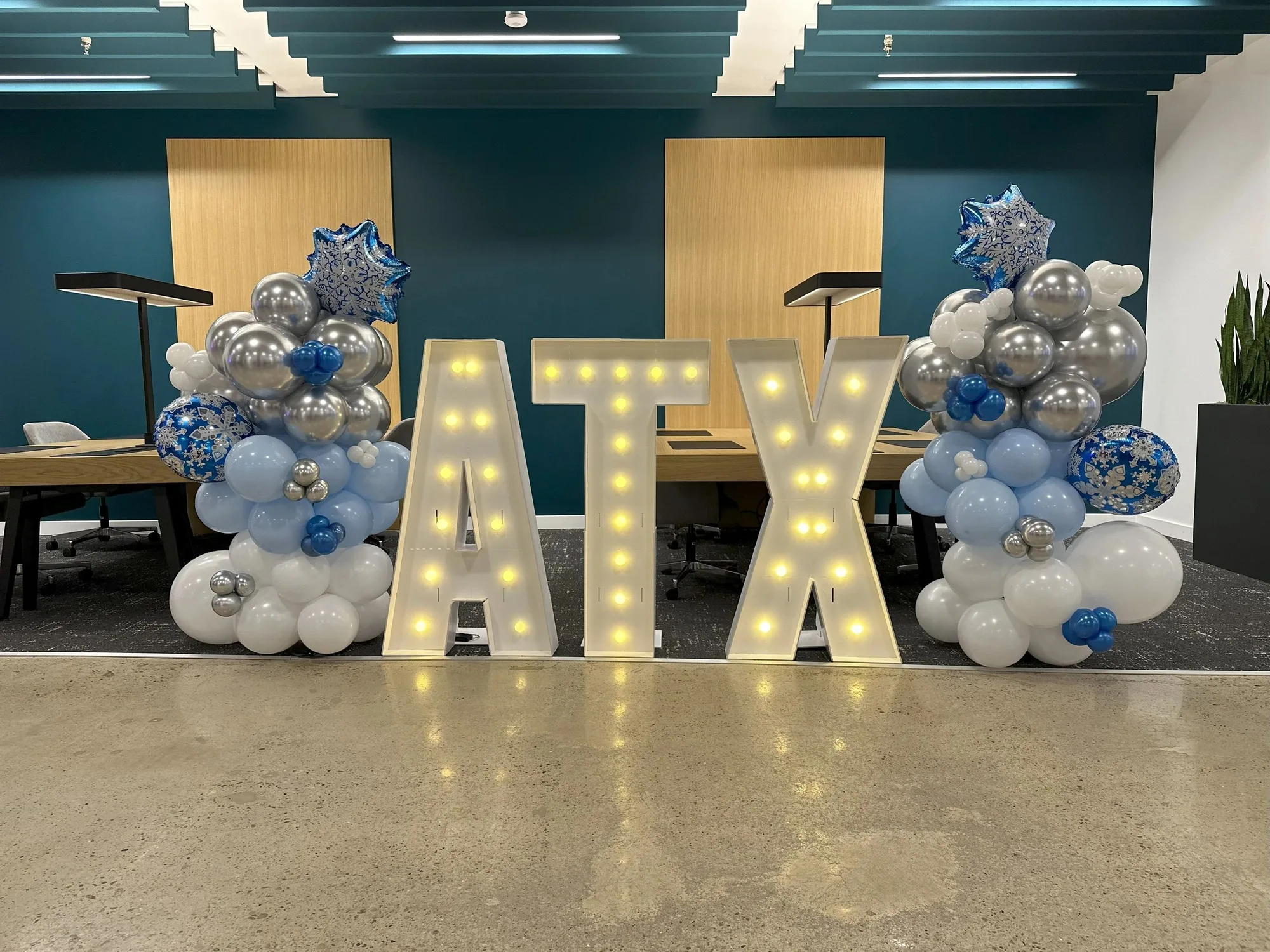 Pair of blue, silver, and white snowflake balloon columns