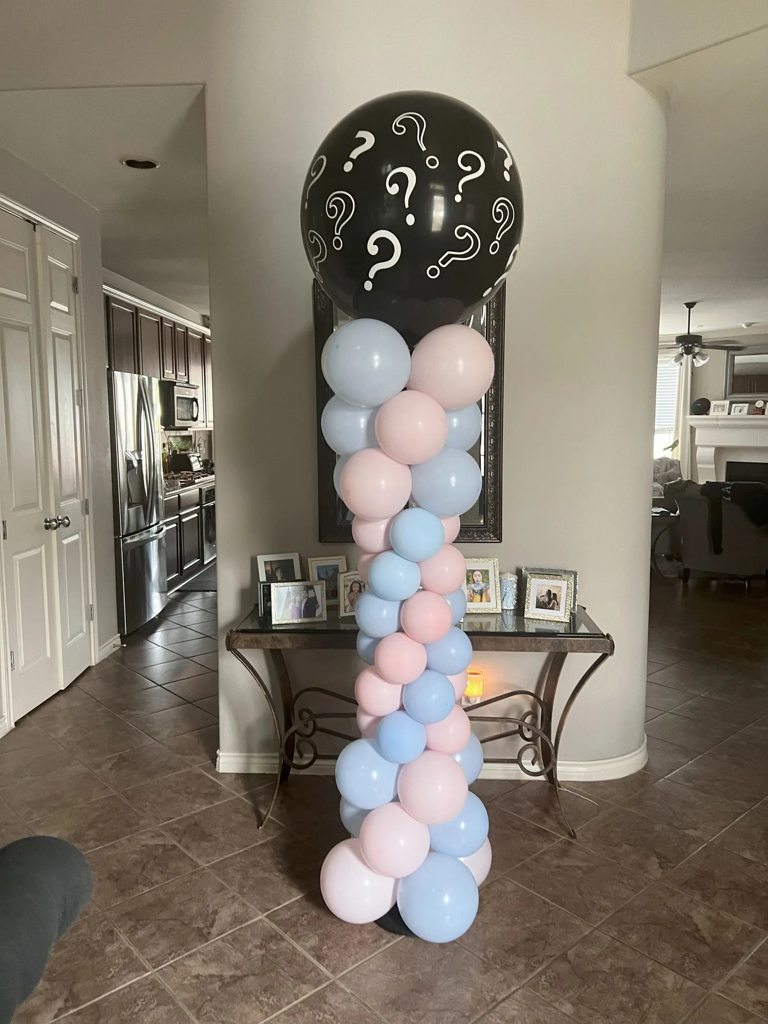 Pink and blue balloon column with a question-mark topper
