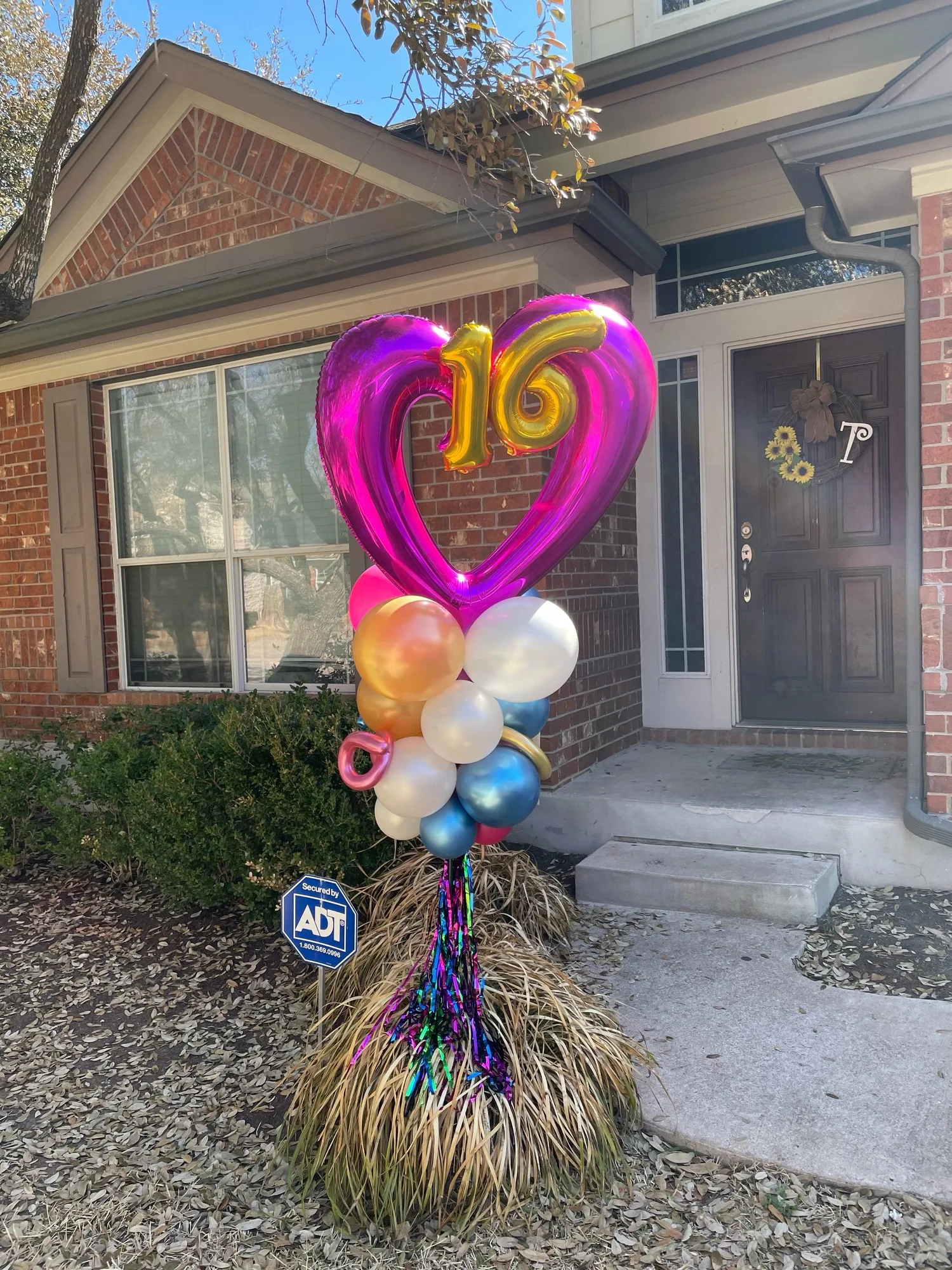 Pink heart and gold sixteen freestanding balloon yard display