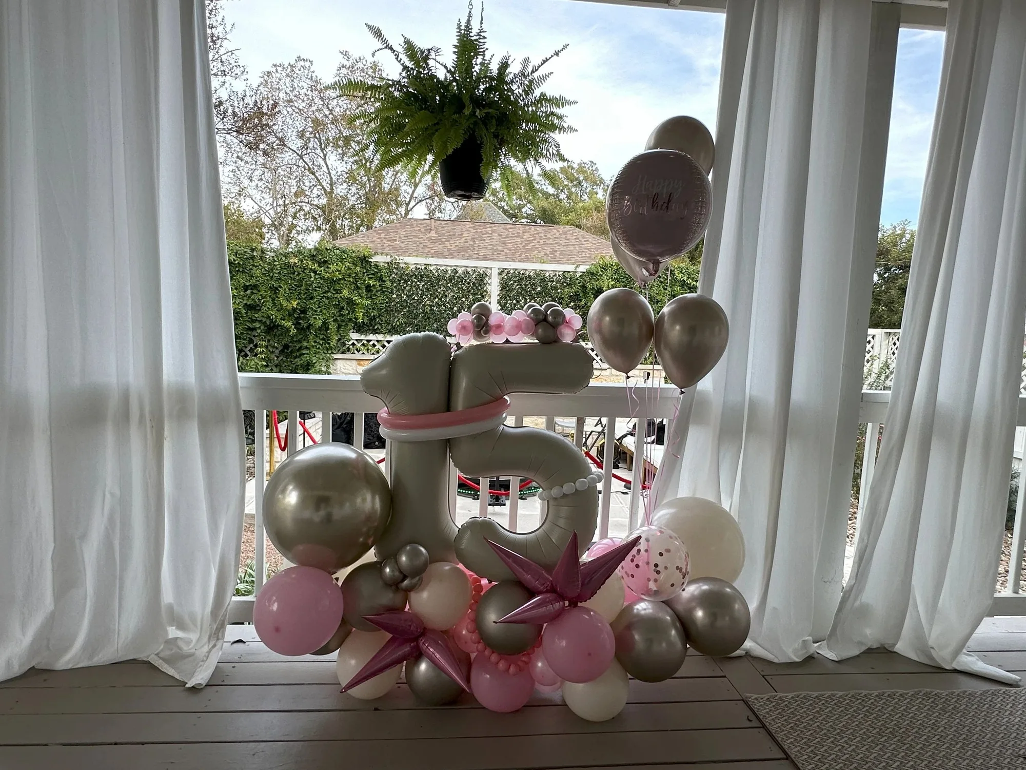 Pink and silver freestanding balloon number fifteen display
