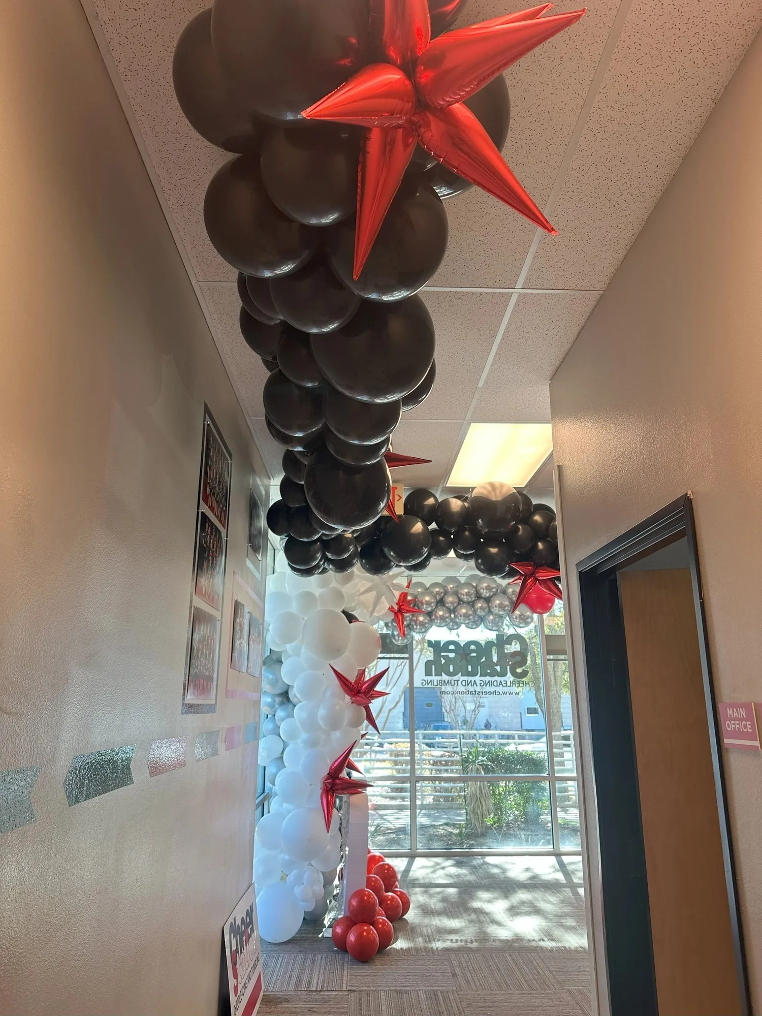 Black, white, and red balloon garland extending through a hallway